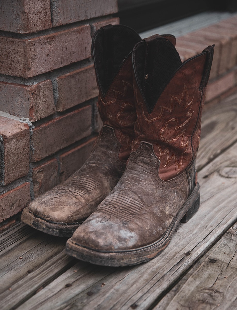 cowboy boots sitting on porch